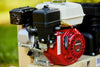 Close-up of the Honda GX gasoline engine on an Ingersoll Rand SS3J5.5GH-WB 5.5 HP single-stage wheelbarrow air compressor