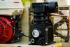 Close-up of the single-stage compressor pump on an Ingersoll Rand SS3J5.5GH-WB 5.5 HP Honda gas-powered air compressor